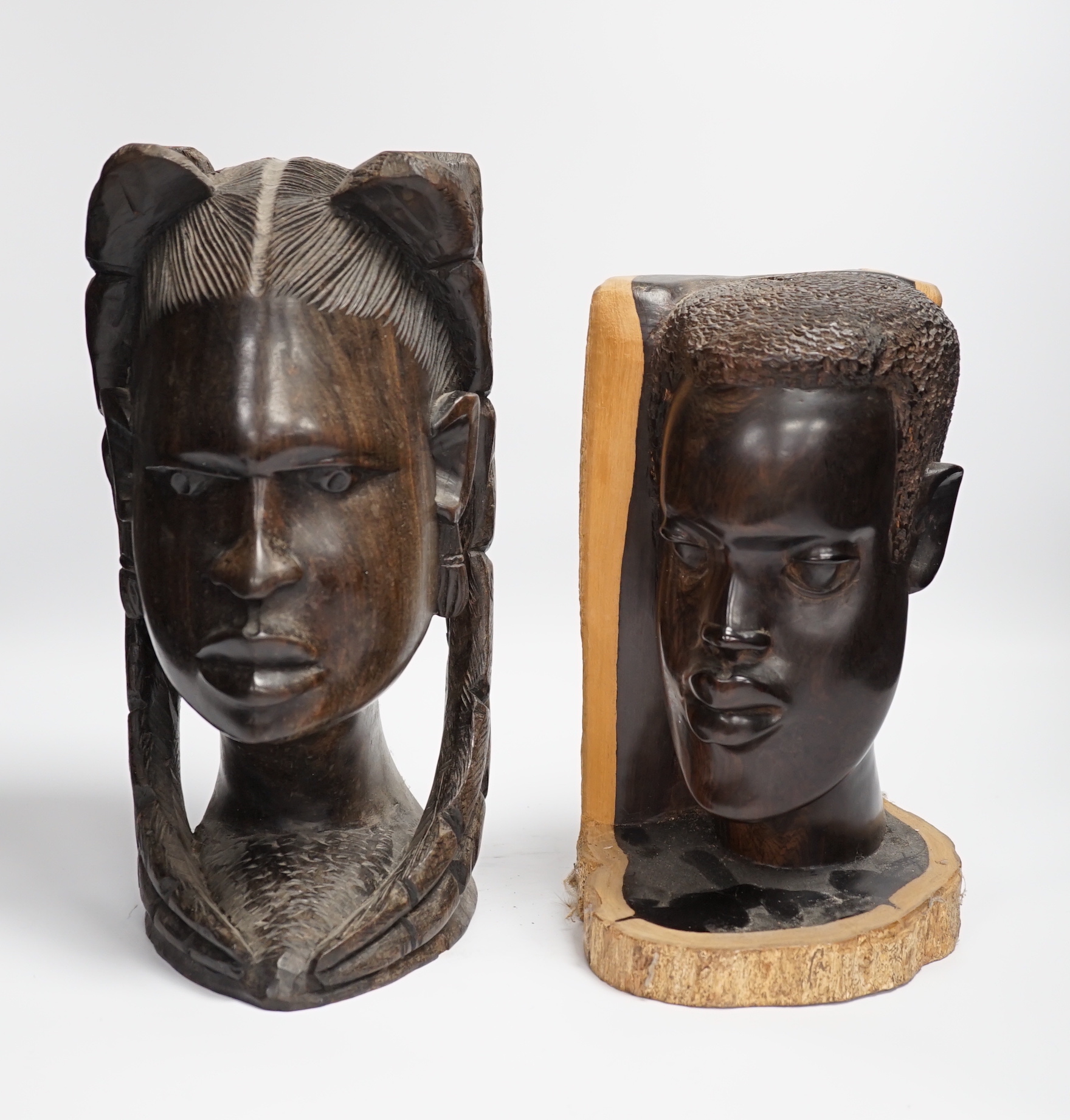 Two carved African ebony busts of a male and female, tallest 30cm high